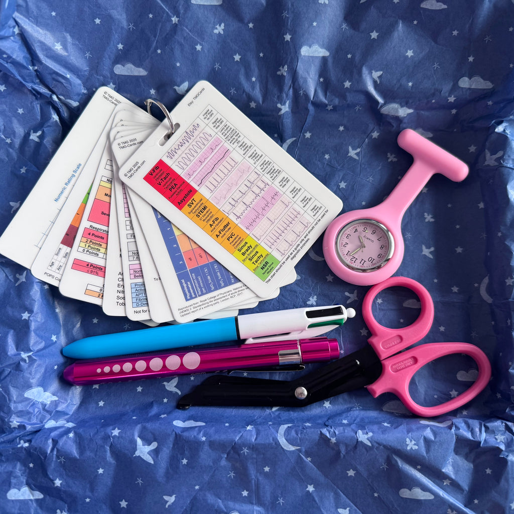 Pink Healthcare Essentials kit with Set of TMG Cards, Pink fob watch, Pink Pen Torch, Pink Scissors and 4 colour pen what has a blue and white body.
